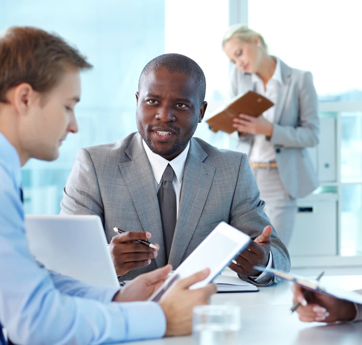 African middle-aged businessman briefing a client